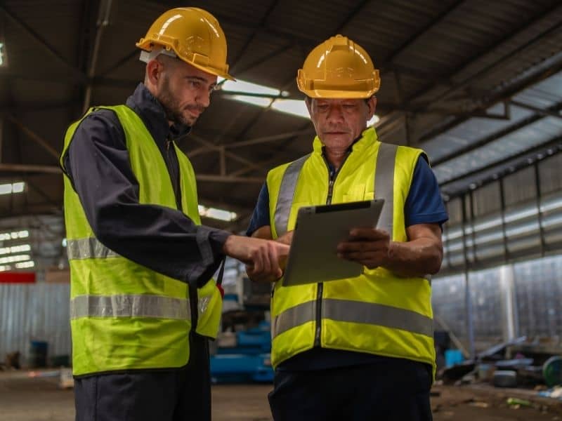 Project professionals reviewing site information while evaluating a former industrial property for redevelopment.