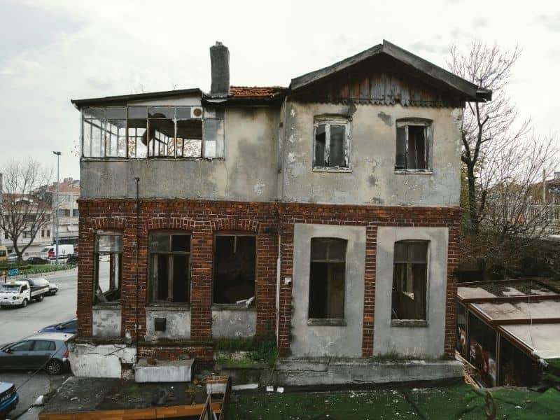 Older residential home awaiting renovation, illustrating why a boundary survey should verify property lines before remodeling or expanding the structure.
