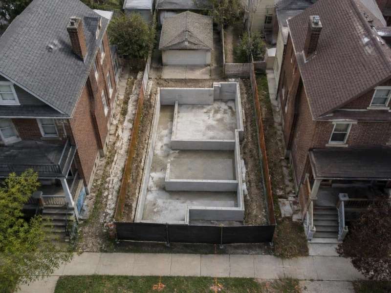 Licensed surveyor performing a construction survey for an urban infill housing project in Cleveland, OH.